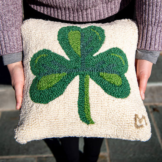 A 3 leaf clover hand hooked pillow, made by Chandler 4 Corners.