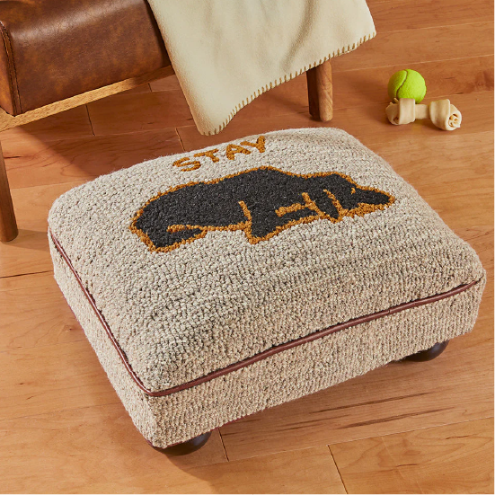 A Chandler 4 Corners bun foot stool with a dog, captioned by the words STAY