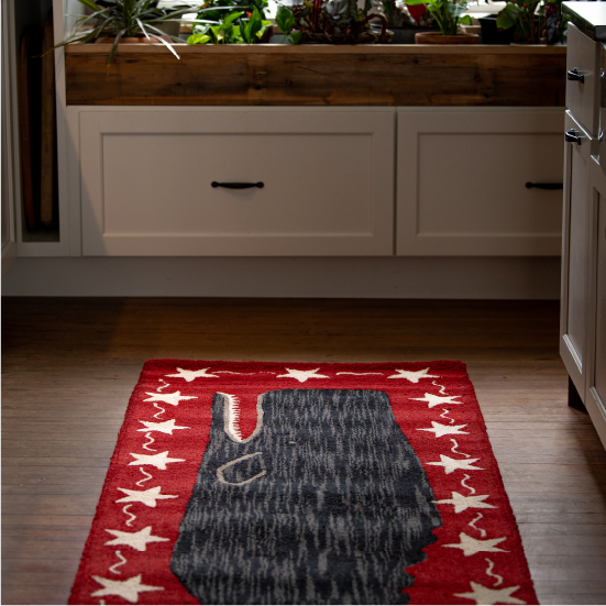 A runner rug of a whale, featured in a kitchen.