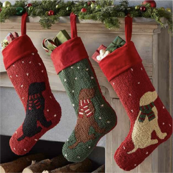 Three Chandler 4 Corners Christmas stockings, hanging above the mantle.